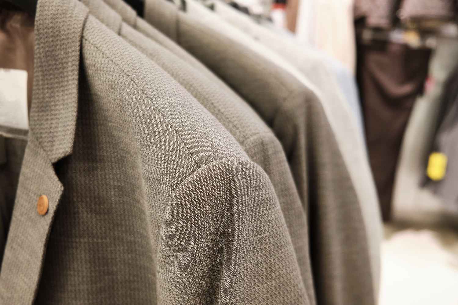 Close-up of a textured gray coat with a blurred background